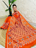 Seated pose showing orange saree pallu with Gujarati stitch geometric pattern