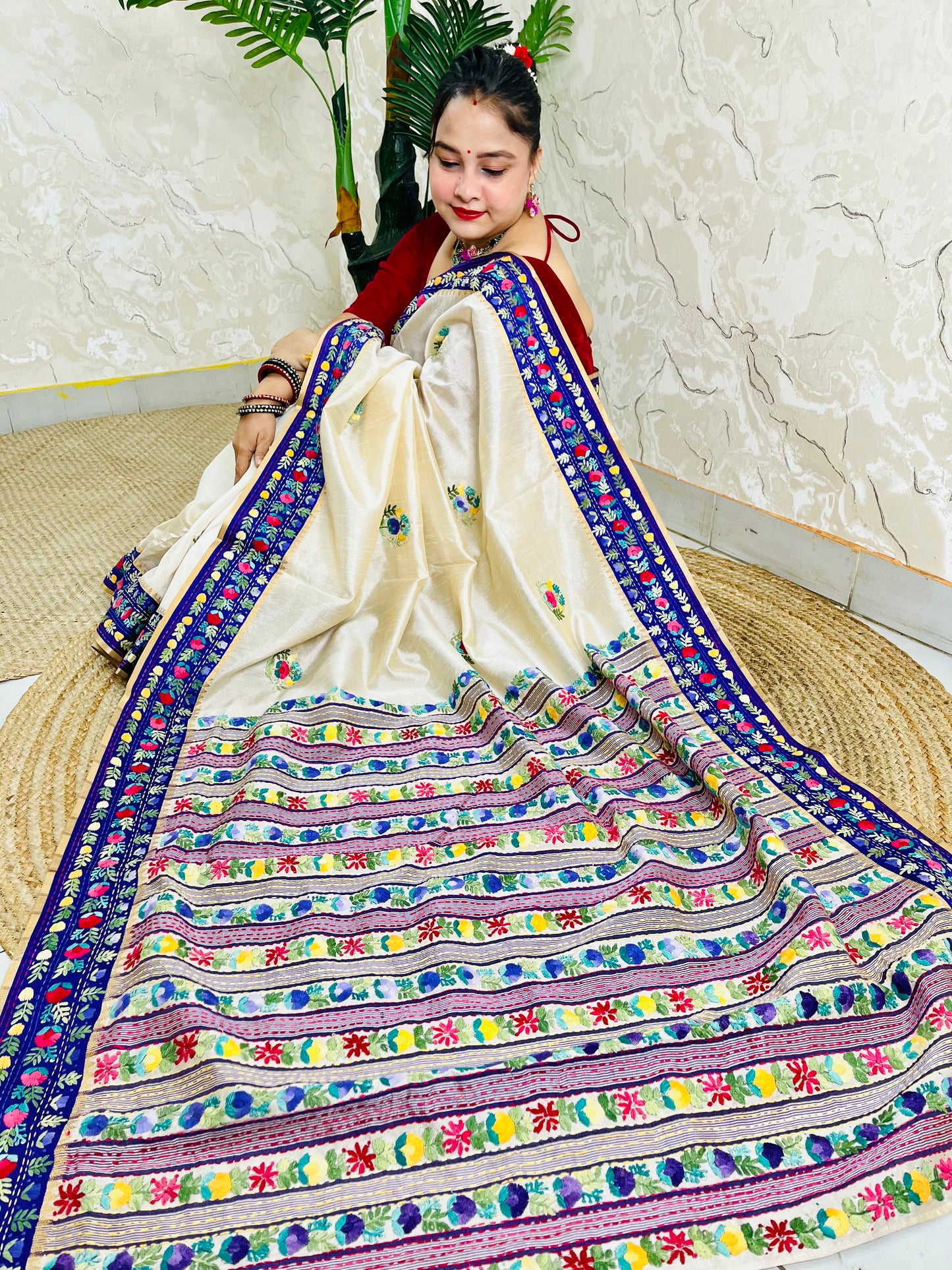 Handwoven Parsi Gara Semi Muga Silk saree with dense multicolour horizontal floral garden stripes pallu and royal blue velvet Kardana border — sitting view, Desi Aadat