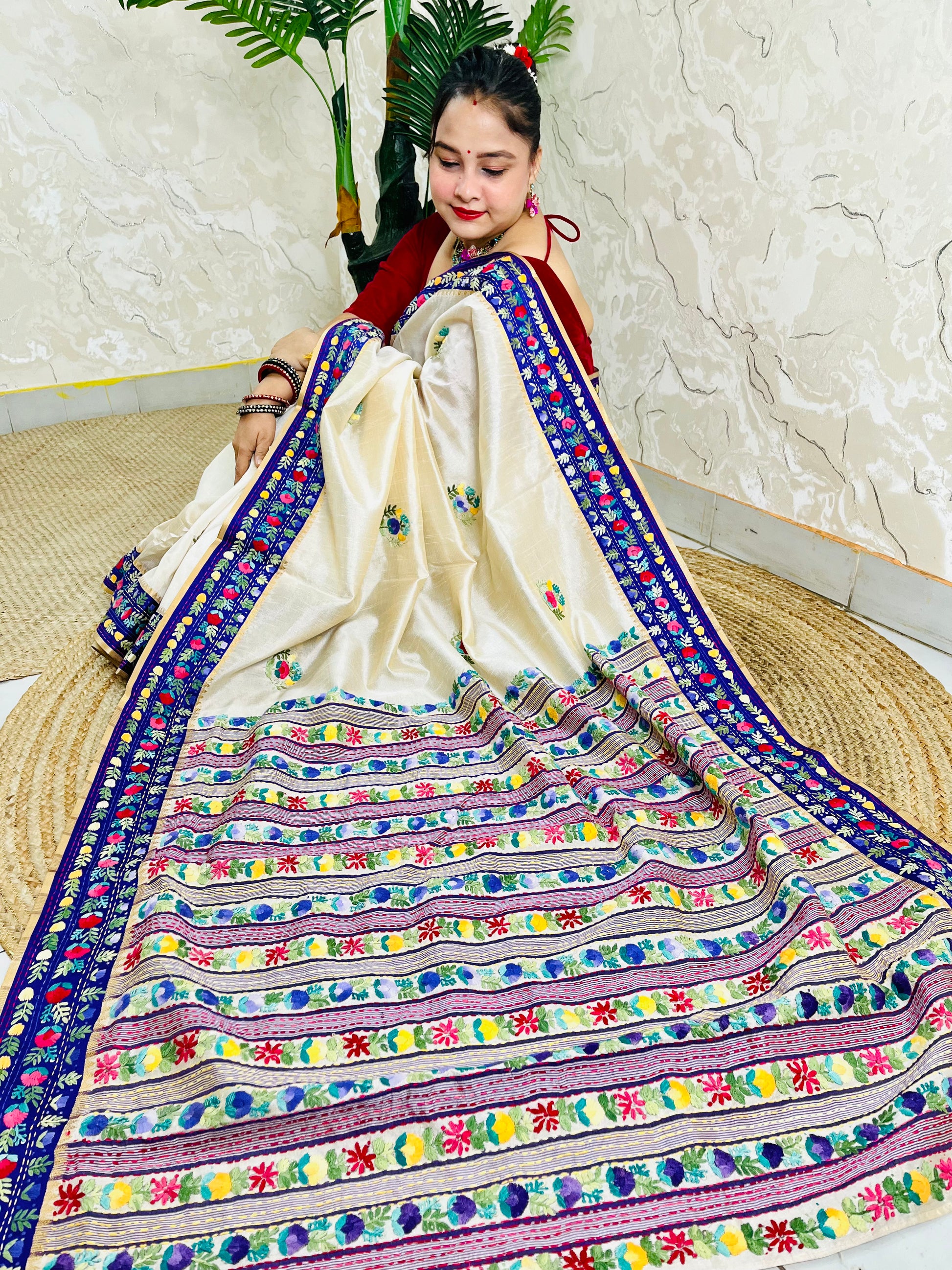 Handwoven Parsi Gara Semi Muga Silk saree with dense multicolour horizontal floral garden stripes pallu and royal blue velvet Kardana border — sitting view, Desi Aadat