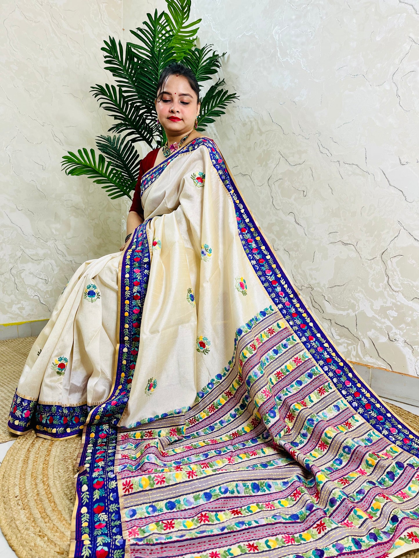Handwoven Parsi Gara Semi Muga Silk saree with dense multicolour horizontal floral garden stripes pallu and royal blue velvet Kardana border — sitting view, Desi Aadat