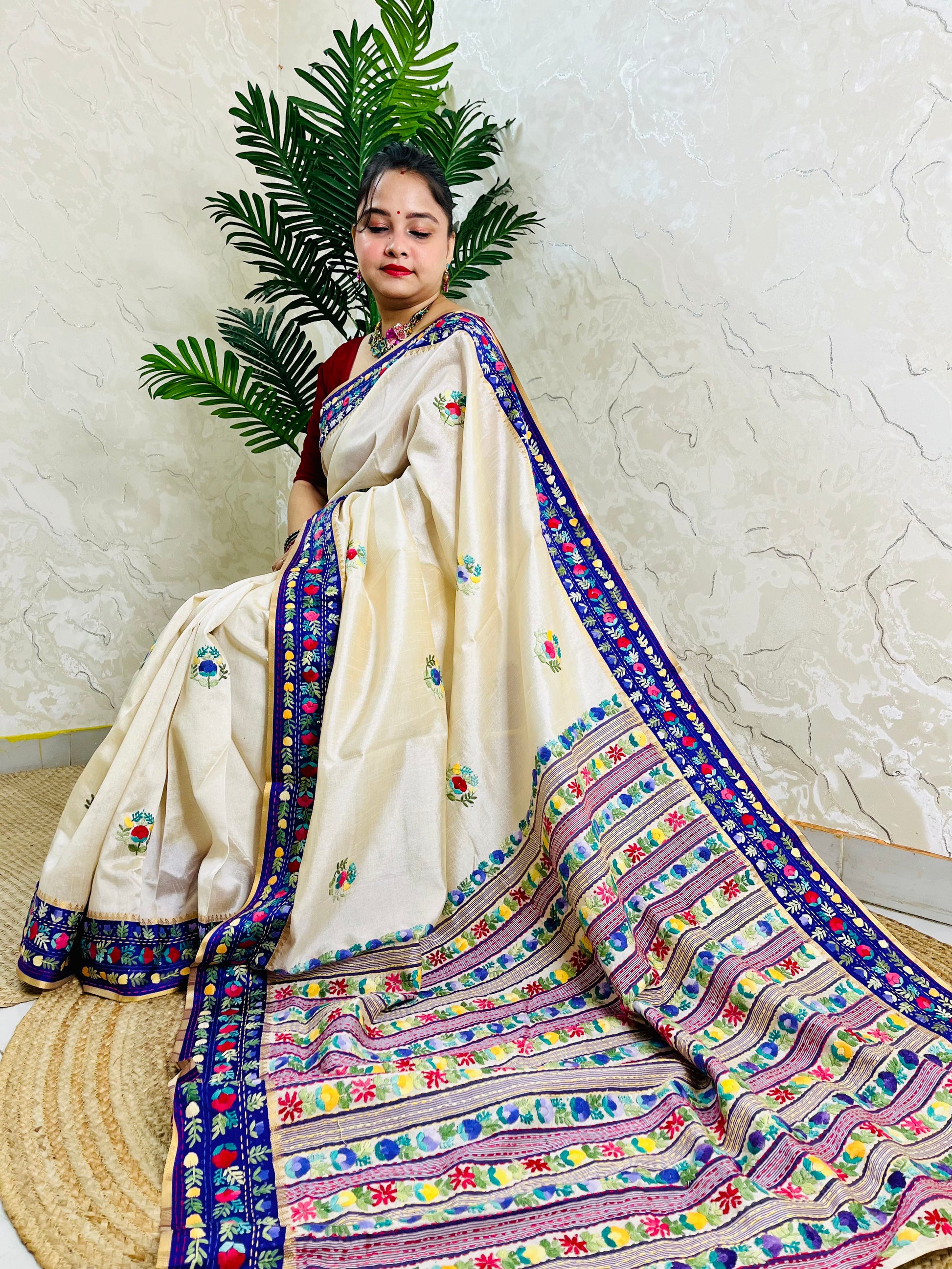 Handwoven Parsi Gara Semi Muga Silk saree with dense multicolour horizontal floral garden stripes pallu and royal blue velvet Kardana border — sitting view, Desi Aadat