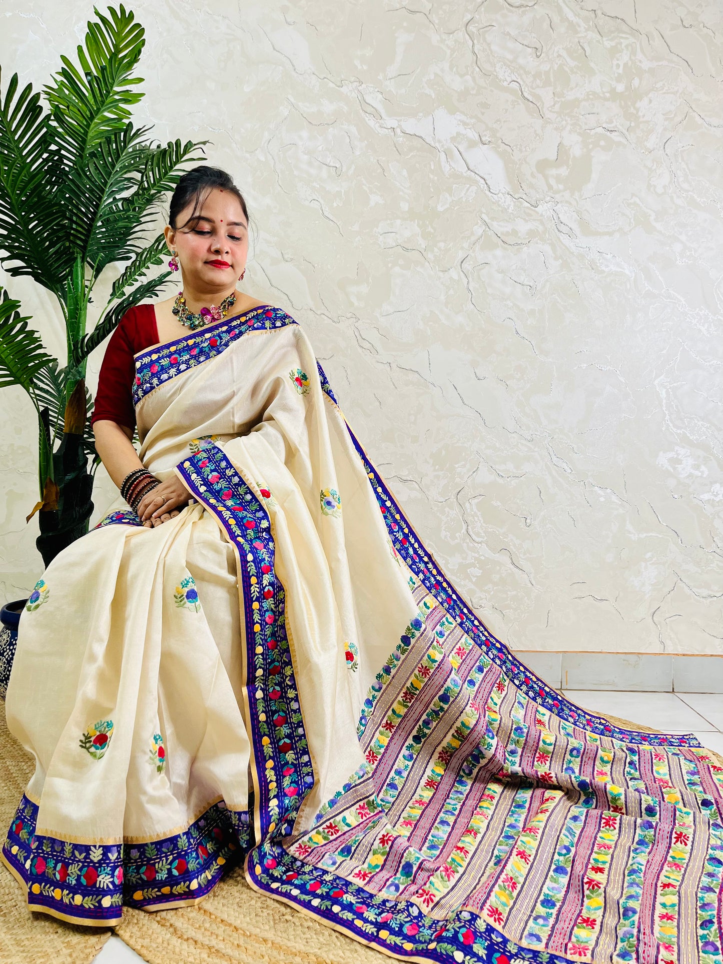 Handwoven Parsi Gara Semi Muga Silk saree with dense multicolour horizontal floral garden stripes pallu and royal blue velvet Kardana border — sitting view, Desi Aadat