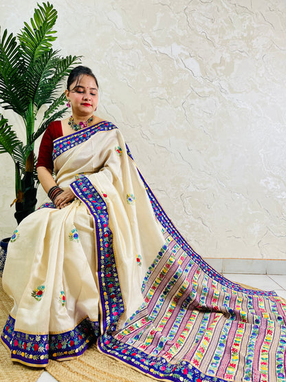 Handwoven Parsi Gara Semi Muga Silk saree with dense multicolour horizontal floral garden stripes pallu and royal blue velvet Kardana border — sitting view, Desi Aadat