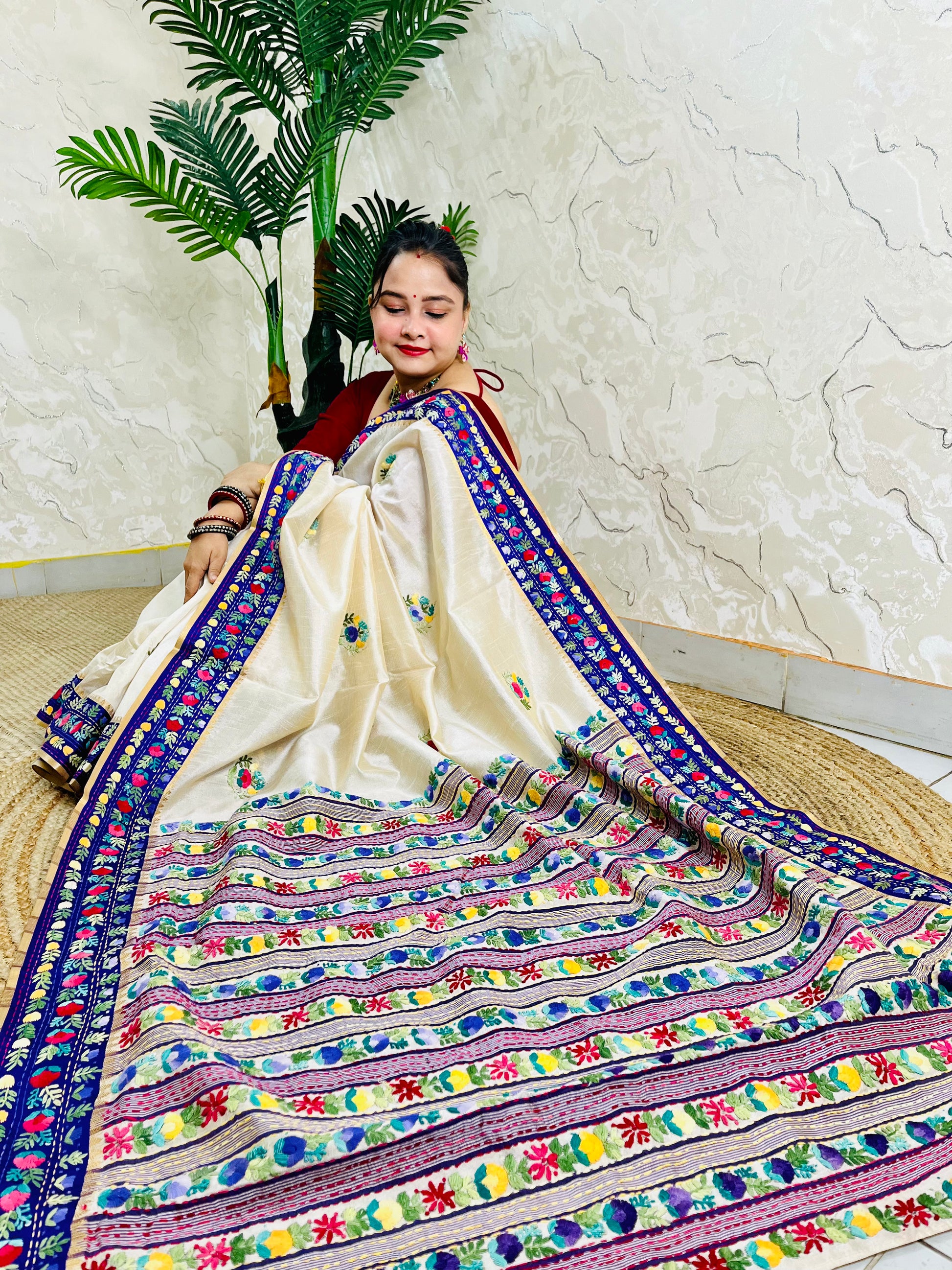 Handwoven Parsi Gara Semi Muga Silk saree with dense multicolour horizontal floral garden stripes pallu and royal blue velvet Kardana border — sitting view, Desi Aadat