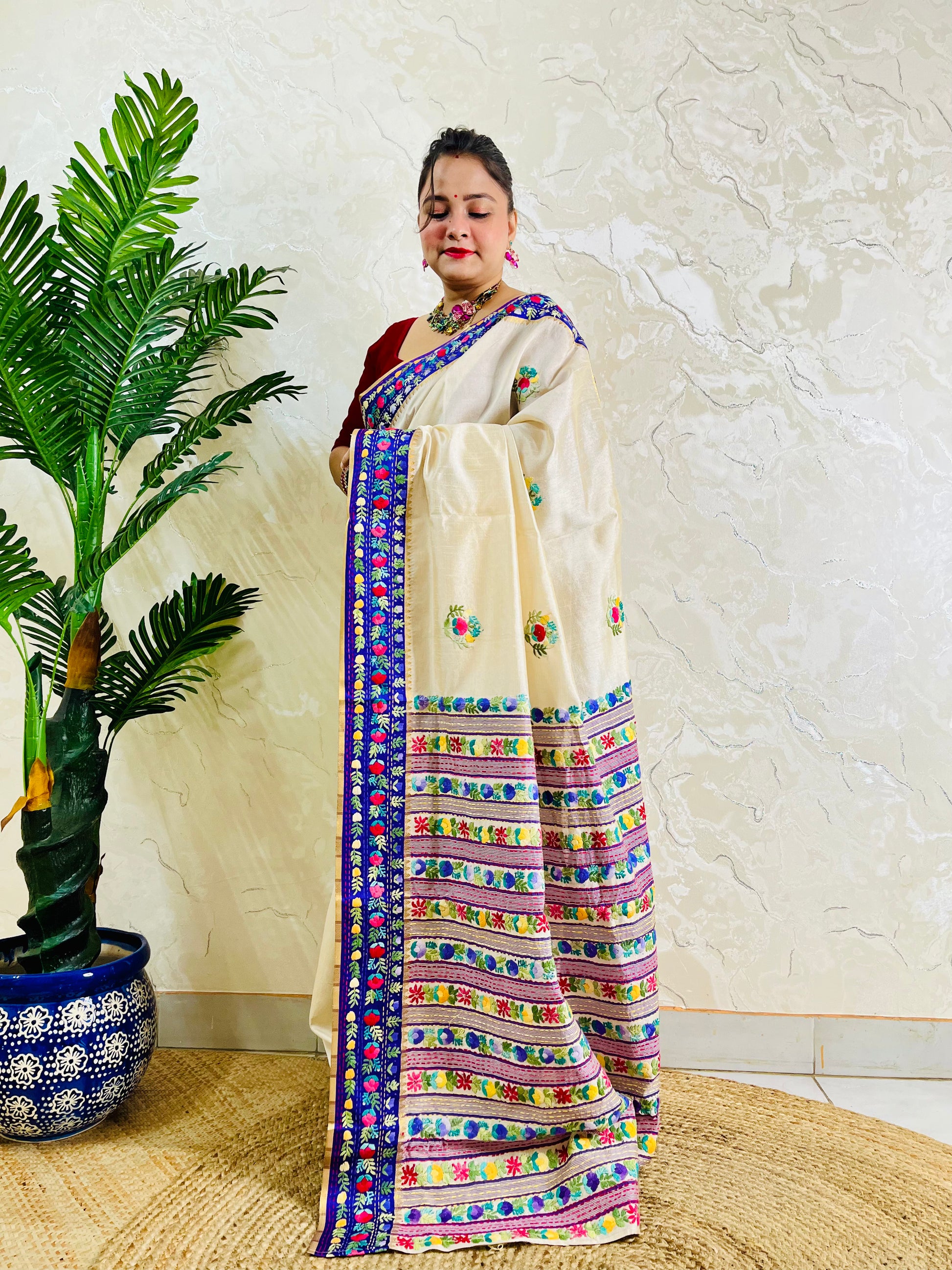 Front standing view of Parsi Gara handwoven Semi Muga Silk saree with scattered butti florals and broad royal blue velvet Parsi Gara embroidered border — heirloom saree by Desi Aadat