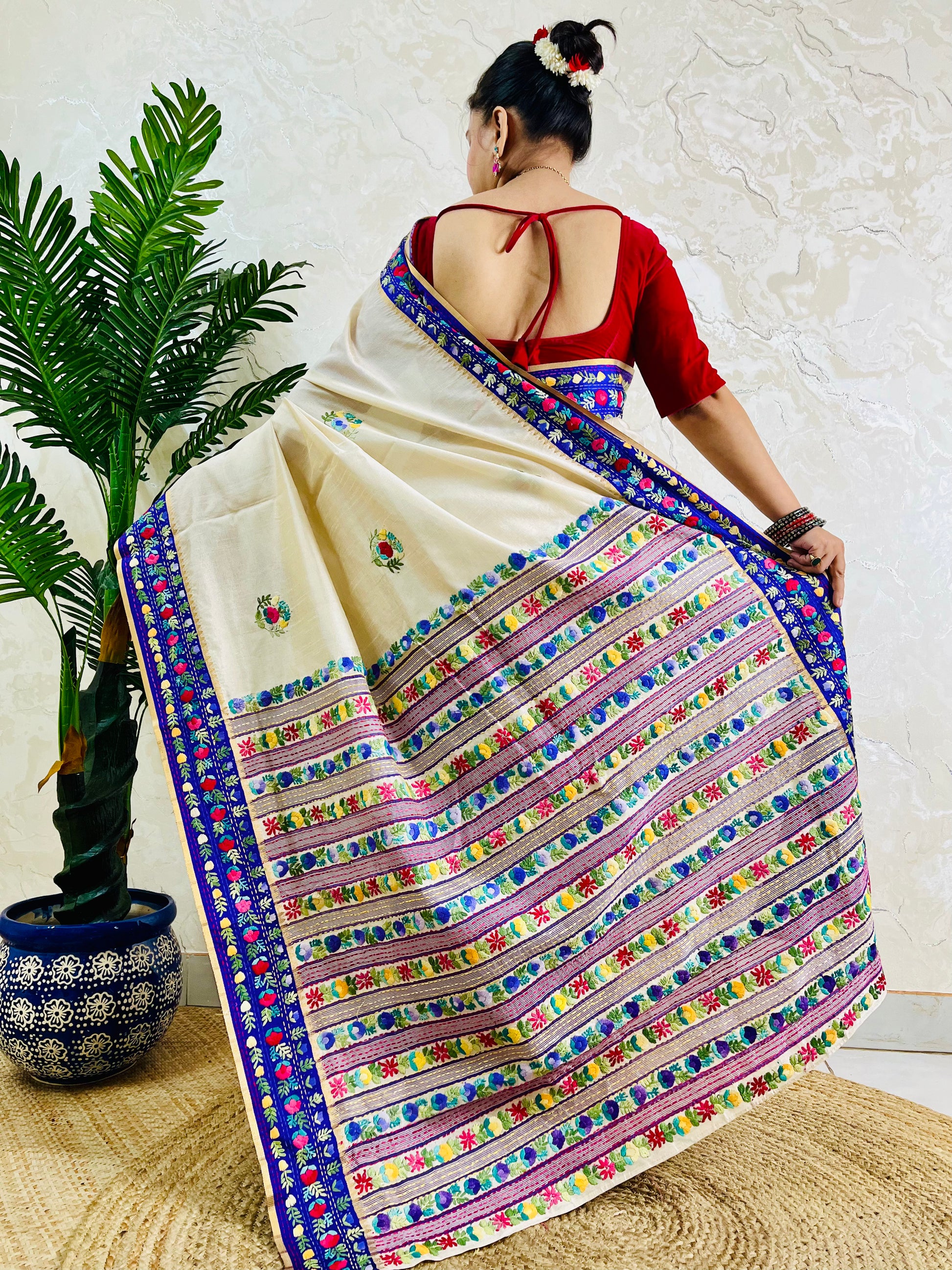 Close-up of Parsi Gara hand-embroidered horizontal floral garden stripes with multicolour blooms and Kardana embellishment on Semi Muga Silk pallu with royal blue velvet border — Desi Aadat