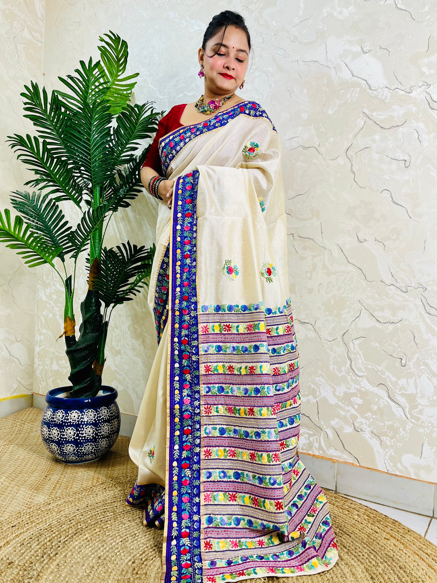 Front standing view of Parsi Gara handwoven Semi Muga Silk saree with scattered butti florals and broad royal blue velvet Parsi Gara embroidered border — heirloom saree by Desi Aadat