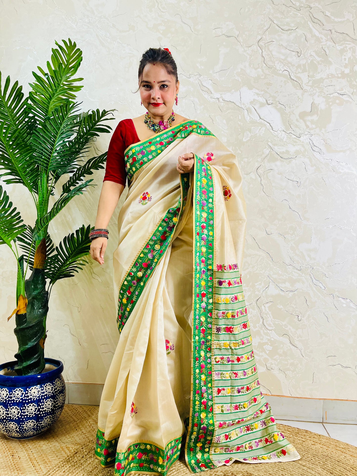 Handwoven Parsi Gara Semi Muga Silk saree with multicolour butti florals and emerald green velvet Kardana embroidered border — standing front view, Desi Aadat