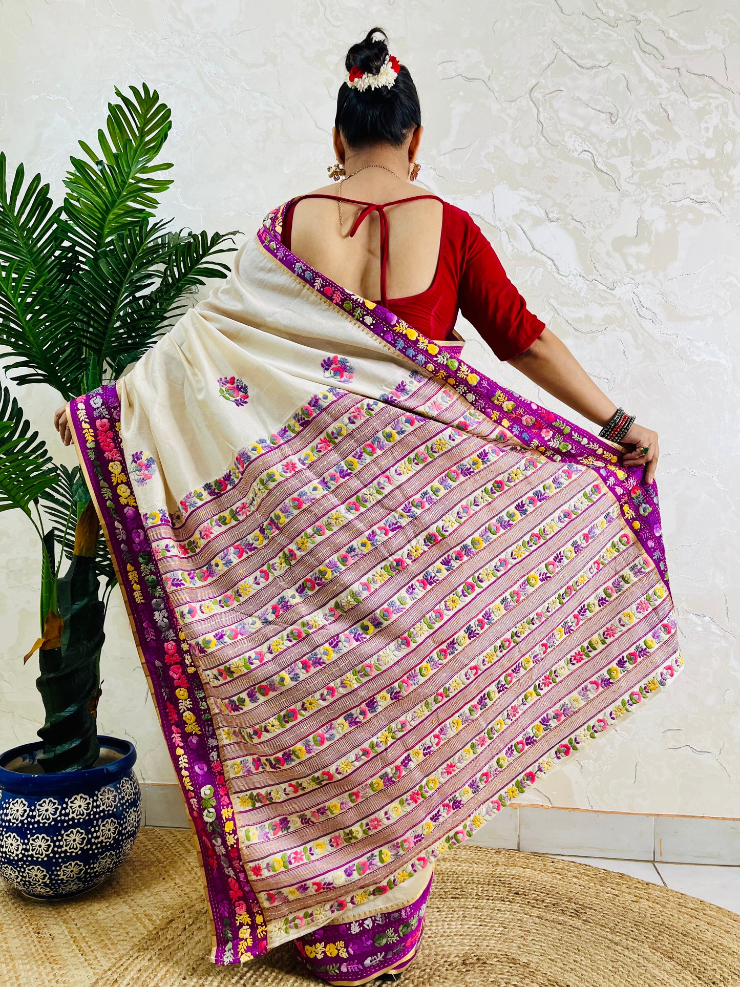 Back view of Parsi Gara handwoven ivory Semi Muga Silk saree with magenta pink velvet border and multicolour Gara floral pallu in motion — Desi Aadat