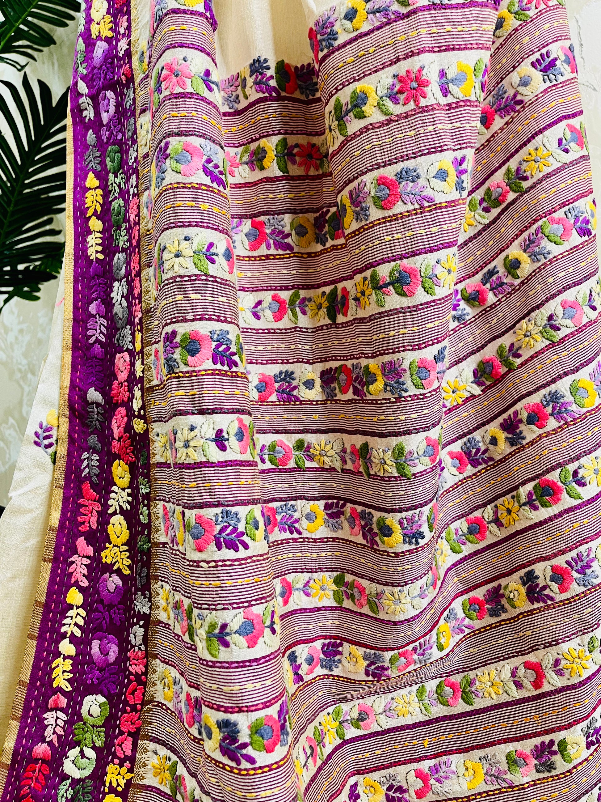 Close-up of Parsi Gara hand-embroidered horizontal floral garden stripes in pink, purple, lavender, coral, and yellow with Kardana gold bead detailing on Semi Muga Silk — Desi Aadat