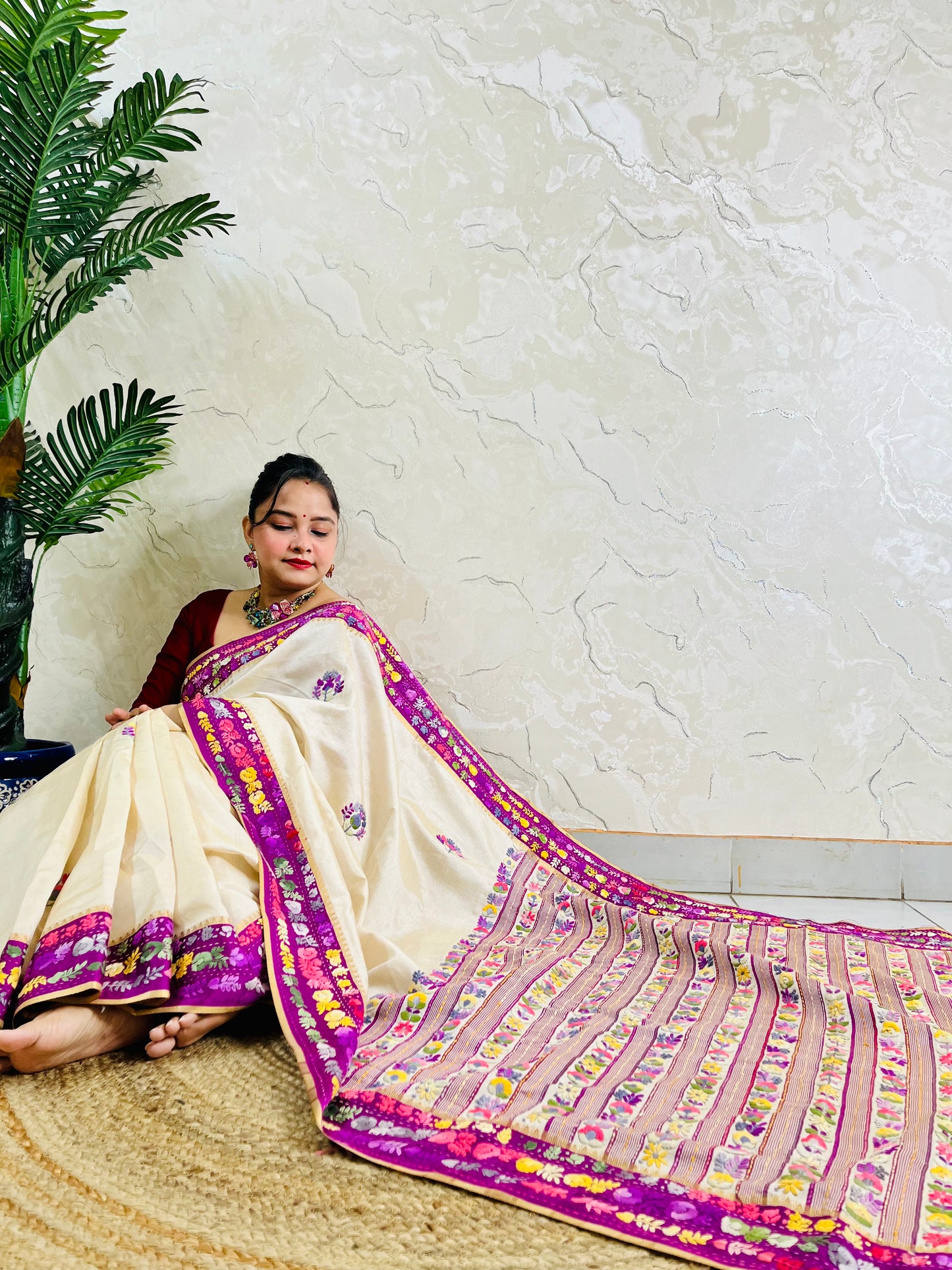 Top sitting view of Parsi Gara Semi Muga Silk saree with dense horizontal multicolour floral garden stripes pallu and magenta pink velvet Kardana border — Desi Aadat