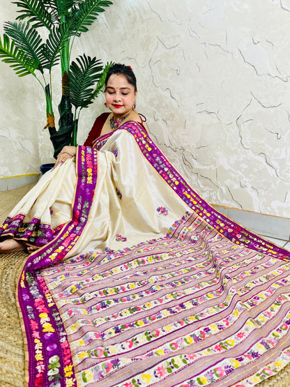 Top sitting view of Parsi Gara Semi Muga Silk saree with dense horizontal multicolour floral garden stripes pallu and magenta pink velvet Kardana border — Desi Aadat