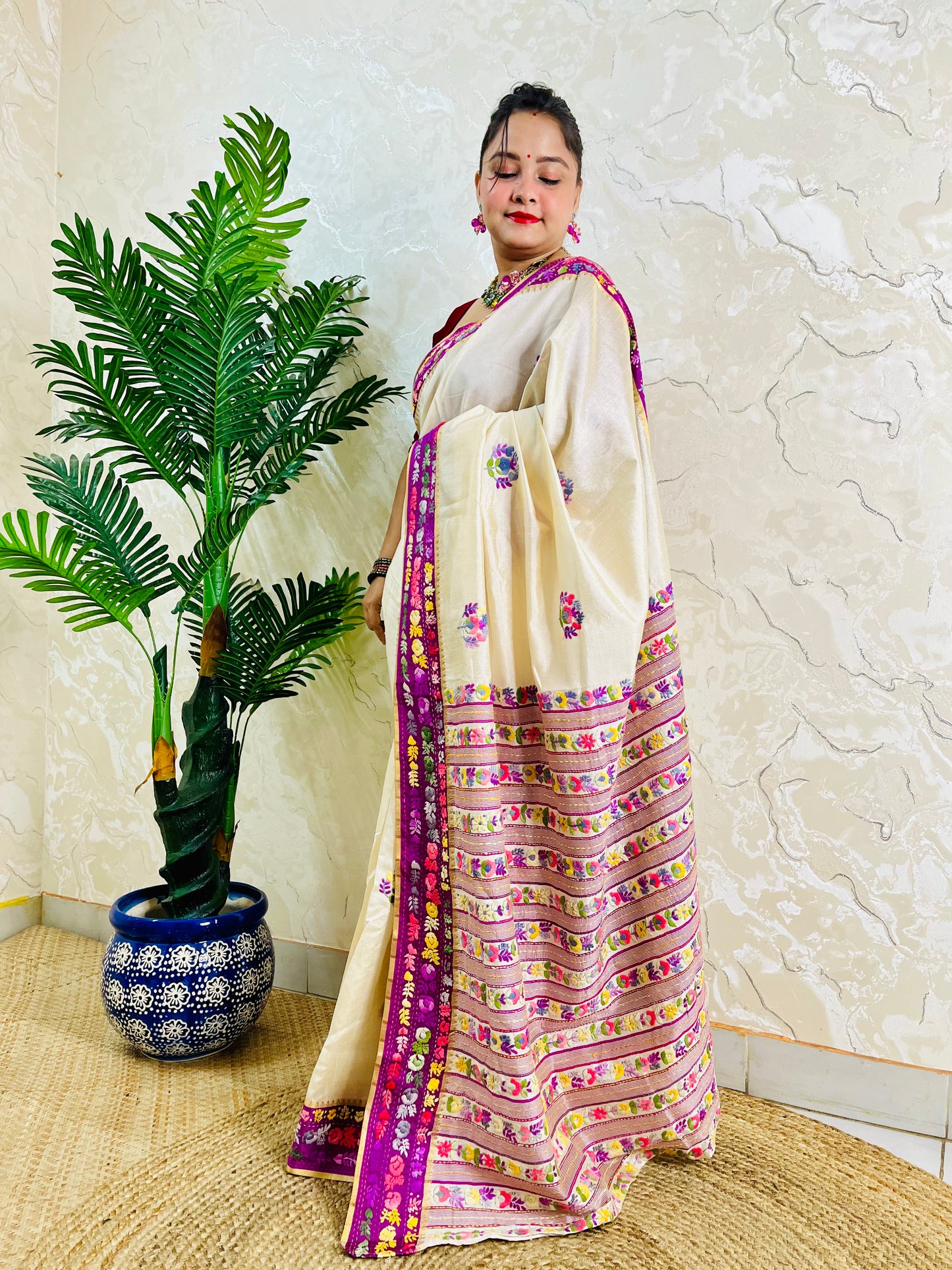 Handwoven Parsi Gara Semi Muga Silk saree with scattered butti florals and deep magenta pink velvet Kardana embroidered border — side standing view, Desi Aadat