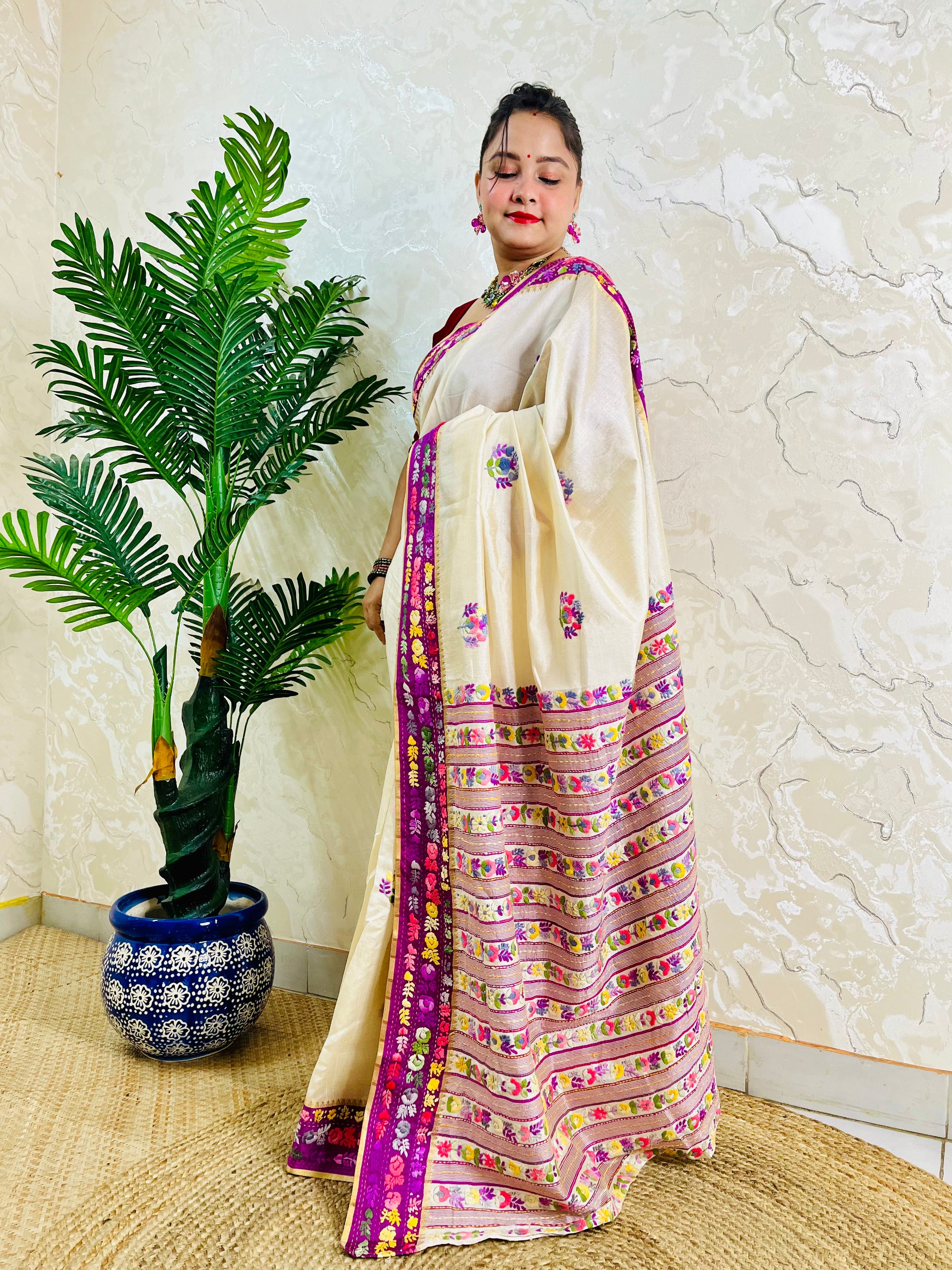 Handwoven Parsi Gara Semi Muga Silk saree with scattered butti florals and deep magenta pink velvet Kardana embroidered border — side standing view, Desi Aadat