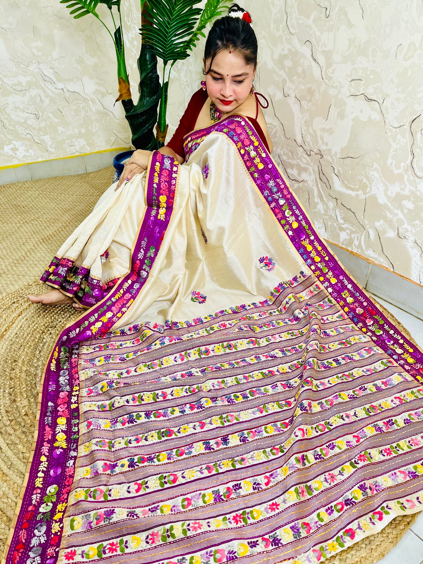 Top sitting view of Parsi Gara Semi Muga Silk saree with dense horizontal multicolour floral garden stripes pallu and magenta pink velvet Kardana border — Desi Aadat