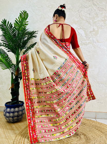 Front standing view of Parsi Gara handwoven Semi Muga Silk saree with red velvet border and multicolour floral embroidery — heirloom saree by Desi Aadat