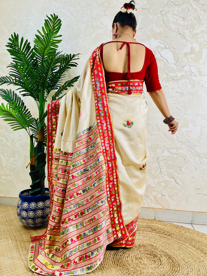 Front standing view of Parsi Gara handwoven Semi Muga Silk saree with red velvet border and multicolour floral embroidery — heirloom saree by Desi Aadat