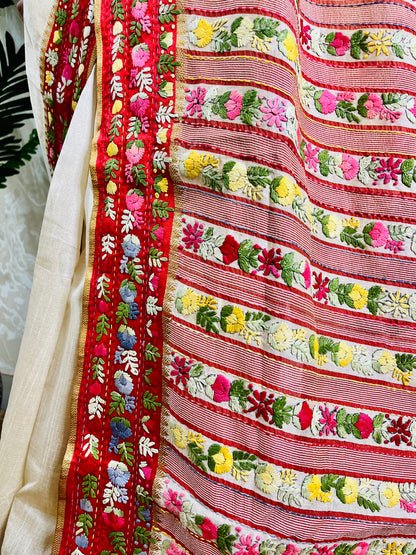 Close-up of Parsi Gara hand-embroidered horizontal floral garden stripes with Kardana work on handwoven Semi Muga Silk saree with red velvet border — Desi Aadat