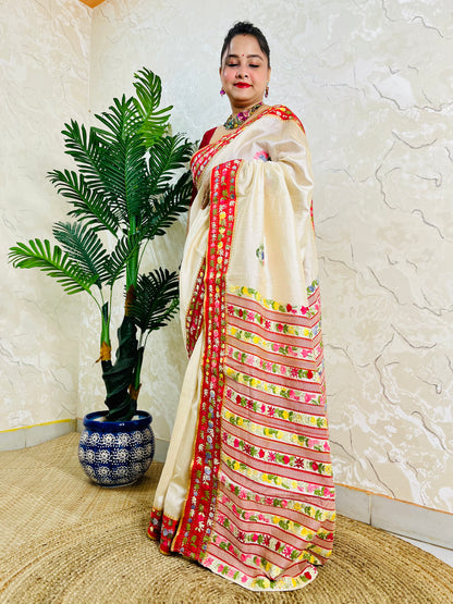 Front standing view of Parsi Gara handwoven Semi Muga Silk saree with red velvet border and multicolour floral embroidery — heirloom saree by Desi Aadat