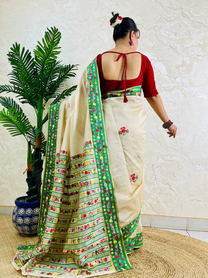 Back view of Parsi Gara handwoven Semi Muga Silk saree with emerald green velvet Kardana border and lush horizontal floral garden stripe pallu in motion — Desi Aadat