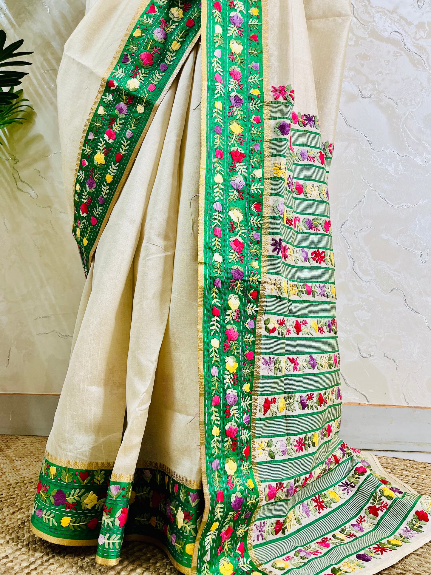 Bottom view of emerald green velvet Parsi Gara embroidered border with Kardana work and multicolour floral hand embroidery on ivory Semi Muga Silk saree — Desi Aadat