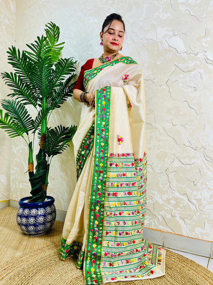Handwoven Parsi Gara Semi Muga Silk saree with multicolour butti florals and emerald green velvet Kardana embroidered border — standing front view, Desi Aadat