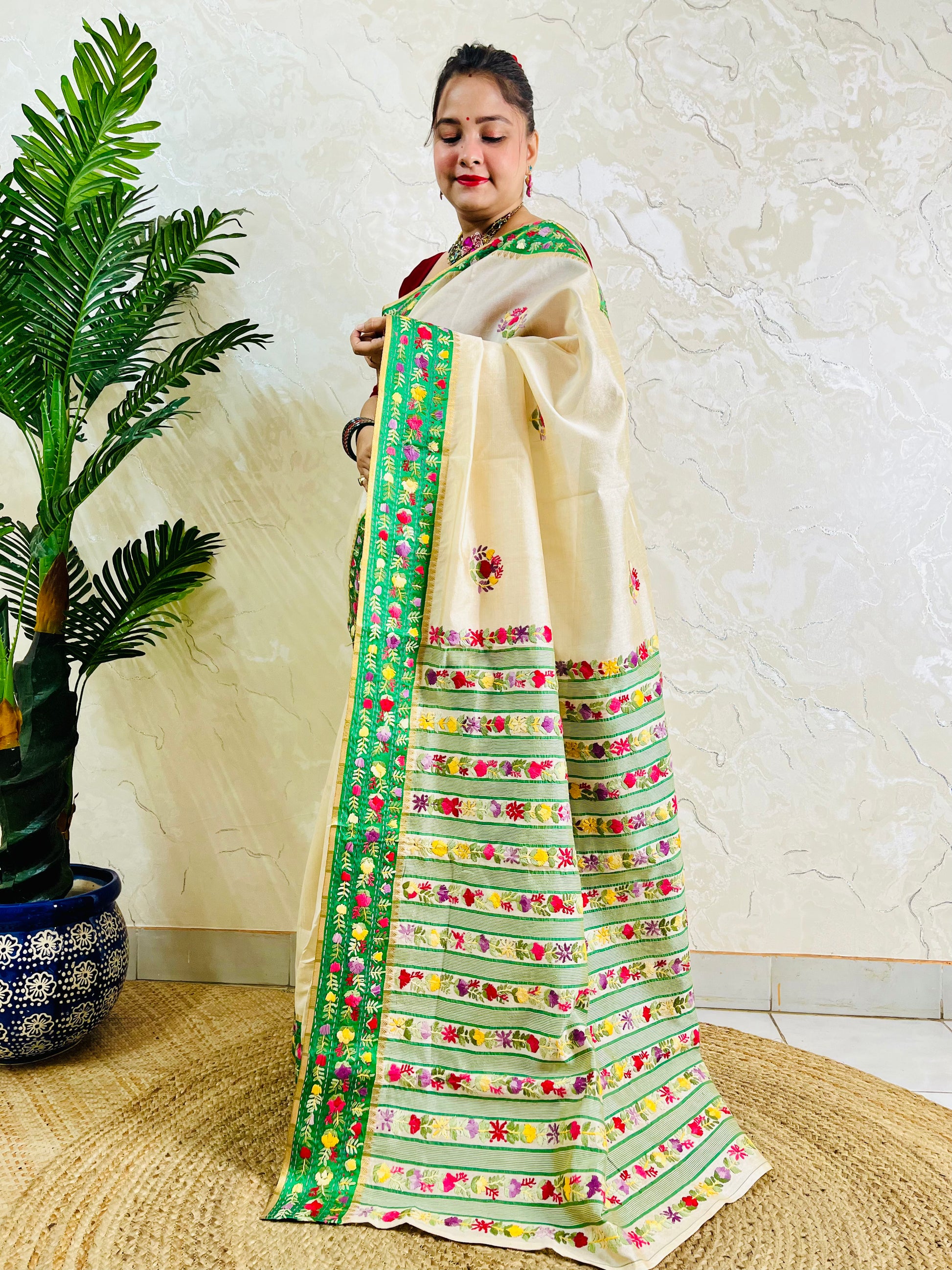 Handwoven Parsi Gara Semi Muga Silk saree with multicolour butti florals and emerald green velvet Kardana embroidered border — standing front view, Desi Aadat