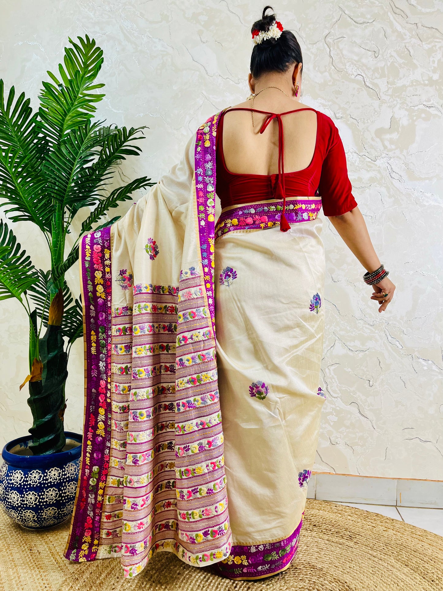 Back view of Parsi Gara handwoven ivory Semi Muga Silk saree with magenta pink velvet border and multicolour Gara floral pallu in motion — Desi Aadat