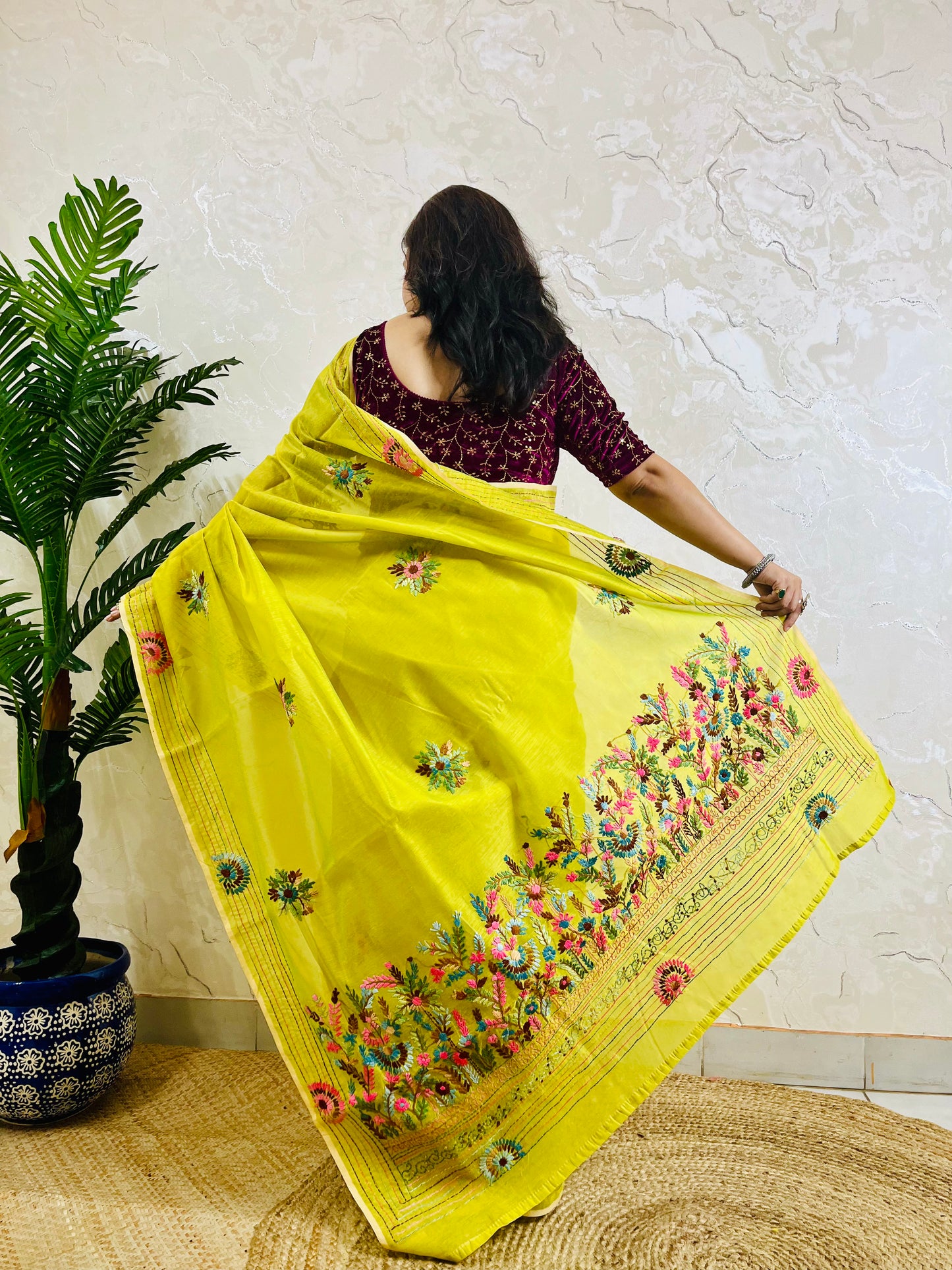 Back view of lemon yellow Parsi Gara Chanderi silk cotton saree with full hand-embroidered garden pallu displayed in motion — Desi Aadat
