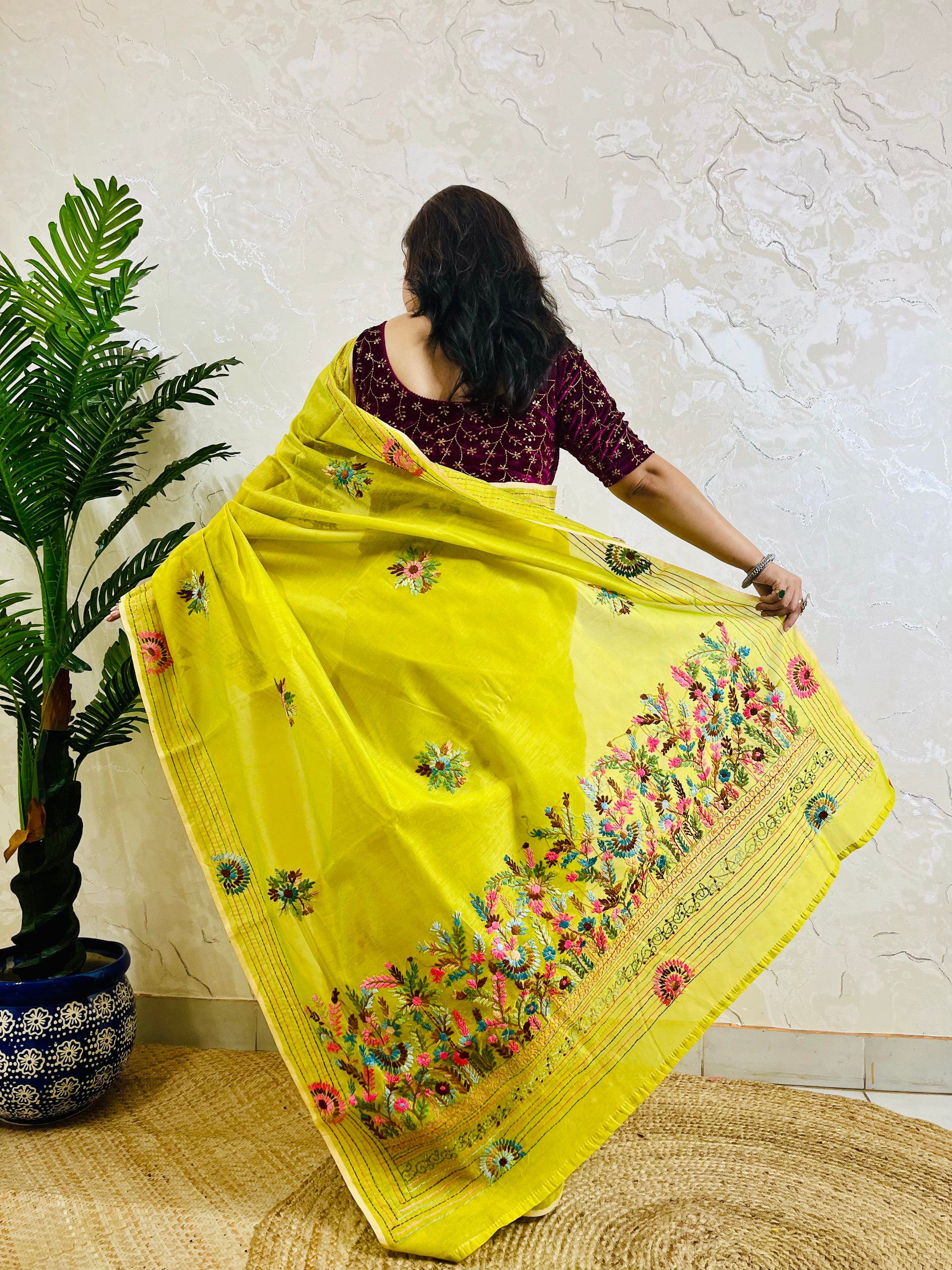 Back view of lemon yellow Parsi Gara Chanderi silk cotton saree with full hand-embroidered garden pallu displayed in motion — Desi Aadat