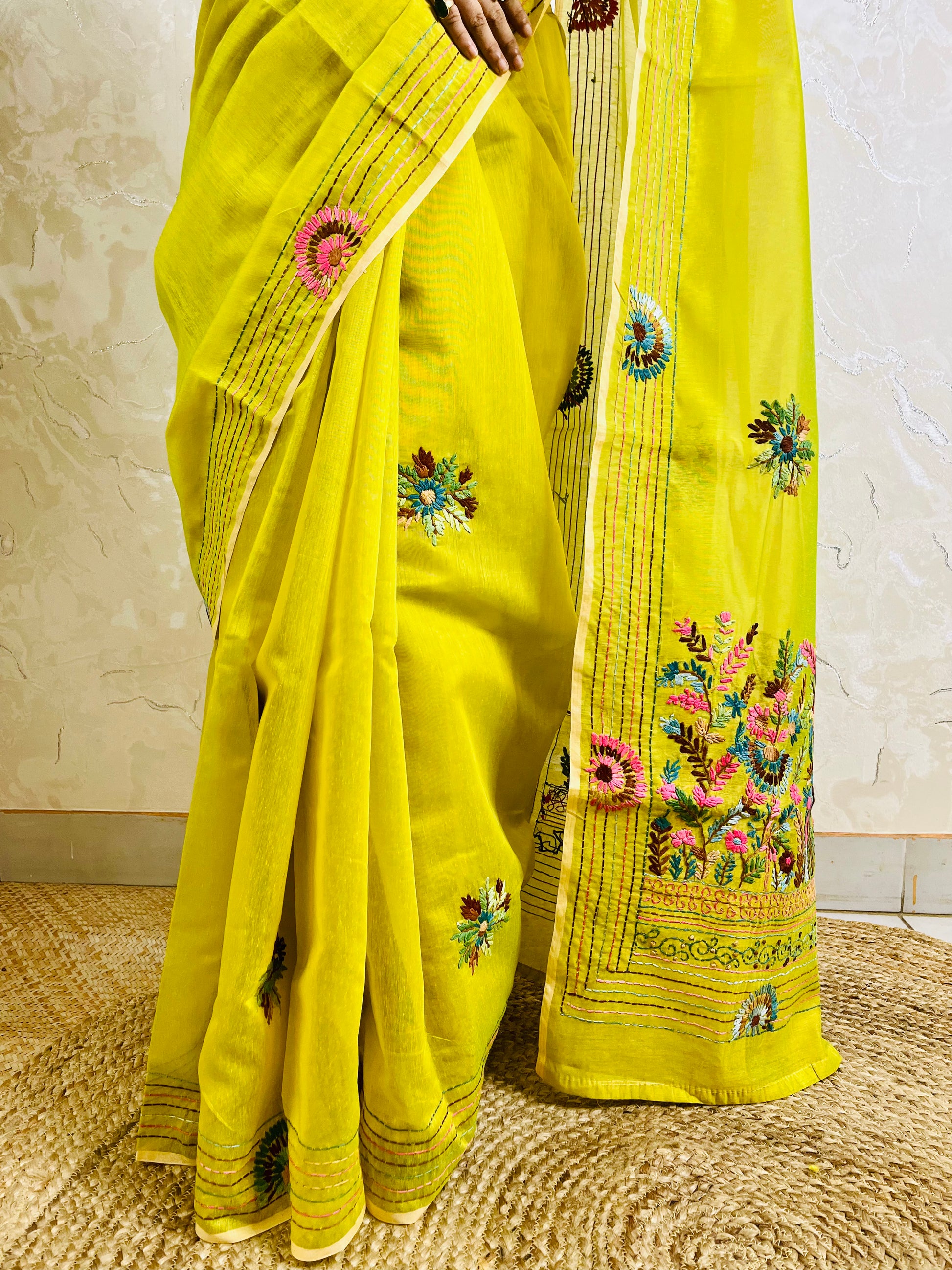 Close-up of handstitched Parsi Gara multicolour floral and daisy medallion embroidery on lemon yellow Chanderi silk cotton saree border — Desi Aadat