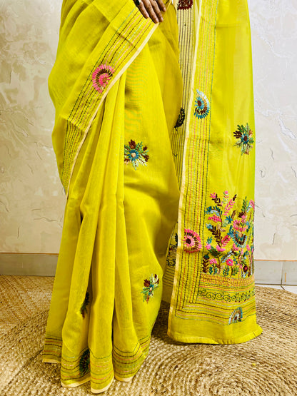 Close-up of handstitched Parsi Gara multicolour floral and daisy medallion embroidery on lemon yellow Chanderi silk cotton saree border — Desi Aadat