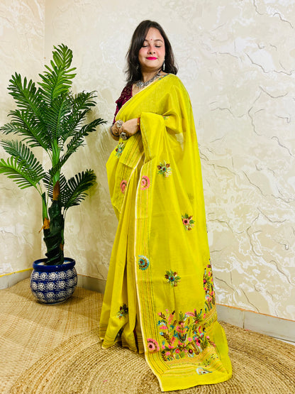 Lemon yellow Parsi Gara handwork Chanderi silk cotton saree with scattered butti florals and multicolour garden border — standing front view, Desi Aadat