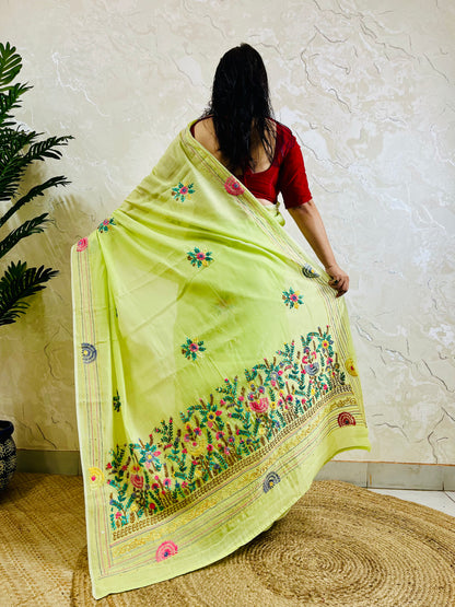 Back view of pastel lime Parsi Gara Chanderi silk cotton saree showing full garden embroidery pallu and scattered butti motifs — Desi Aadat