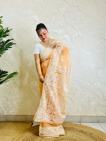 Pastel peach orange Chikankari handstitched organza silk saree with full white jaal and floral embroidery — side standing view, Desi Aadat