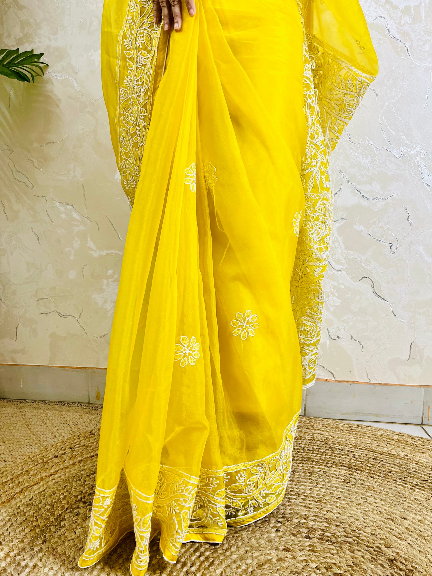 Close-up of dense white handmade Chikankari jaal and floral embroidery on pastel yellow pure organza silk saree — Desi Aadat