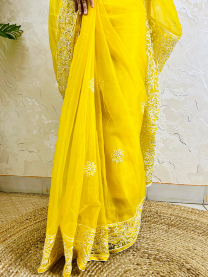 Close-up of dense white handmade Chikankari jaal and floral embroidery on pastel yellow pure organza silk saree — Desi Aadat