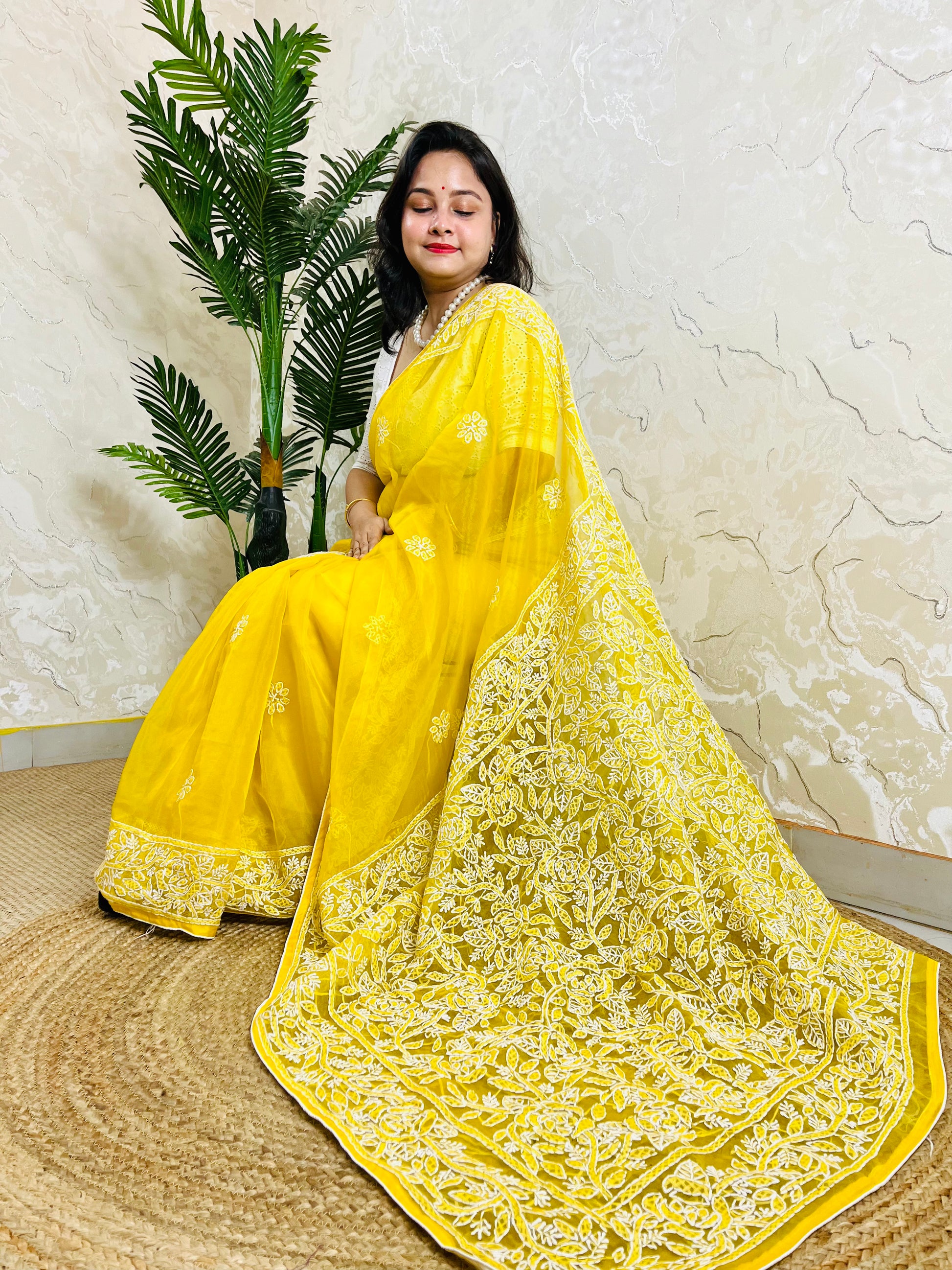 Limited edition pastel yellow Chikankari pure organza silk saree with dense white hand embroidery — sitting drape view by Desi Aadat