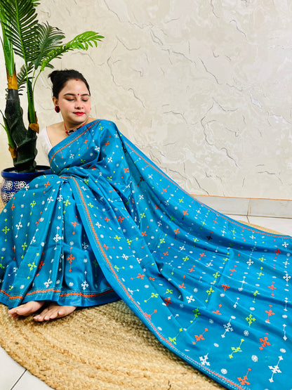 Peacock blue handwoven saree draped with orange and white cross-stitch border