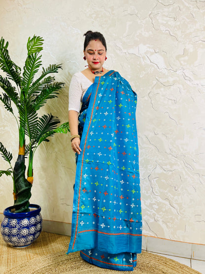 Peacock blue handwoven saree draped with orange and white cross-stitch border