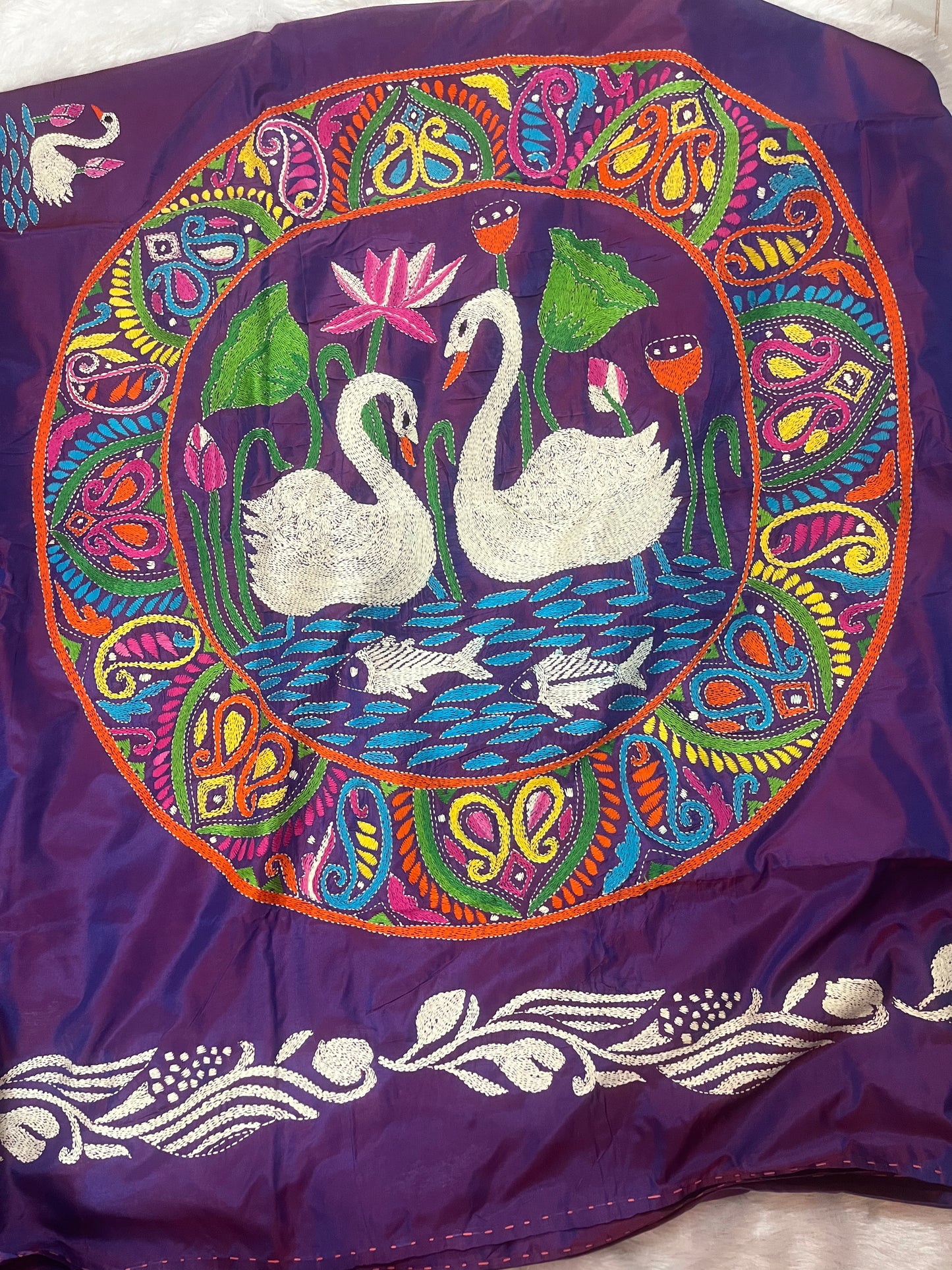 Close-up of swarn golden motif Kantha embroidery on rich purple handwoven fabric