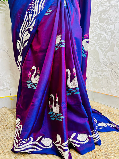 Close-up of swarn golden motif Kantha embroidery on rich purple handwoven fabric