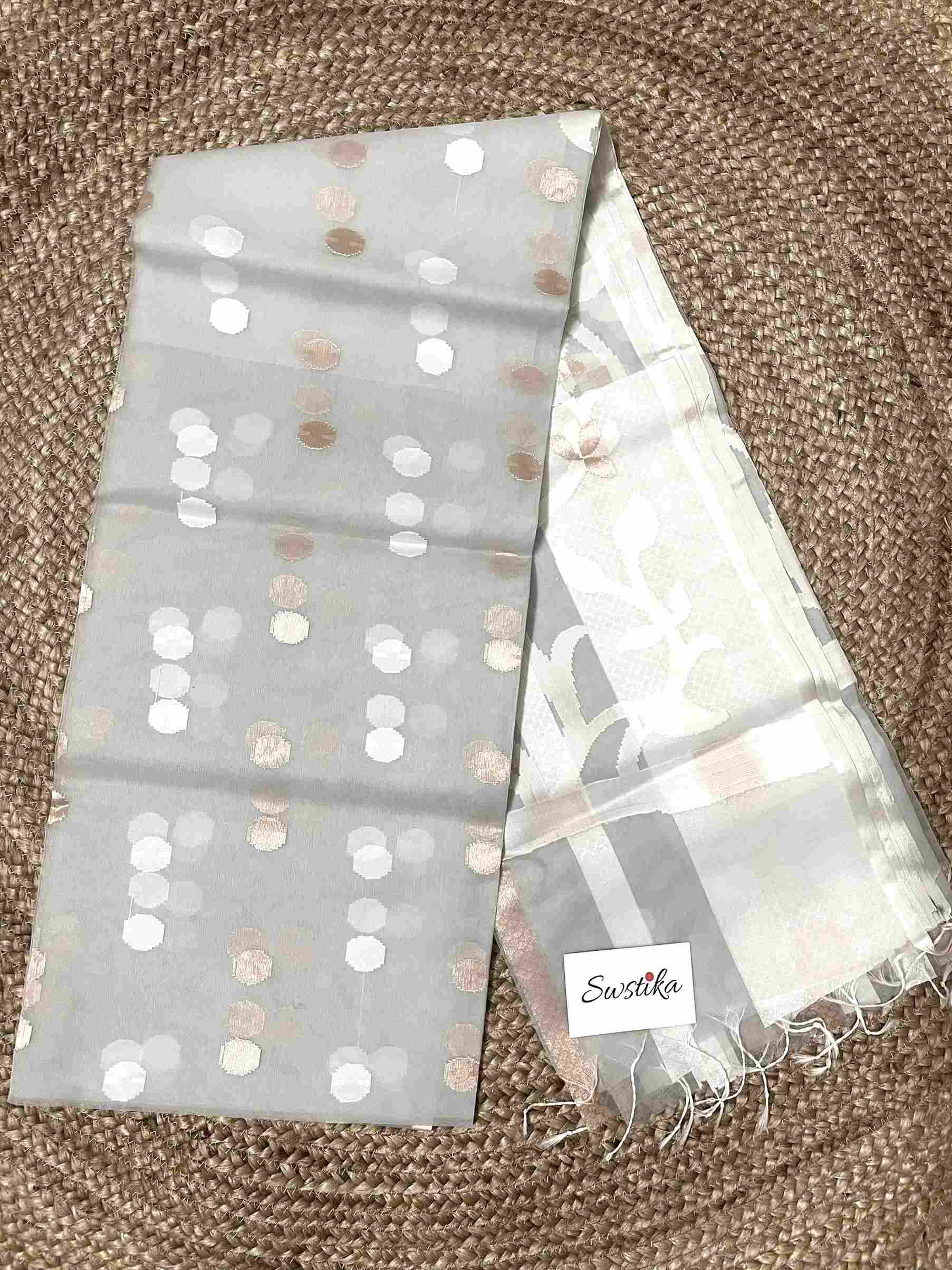 Close-up of Jamdani muslin saree motifs on Light Grey silk fabric