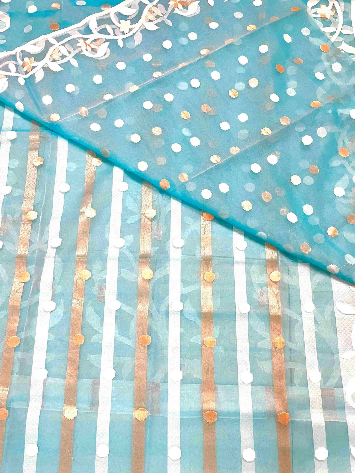 Close-up of Jamdani muslin saree patterns on Sky Blue silk fabric