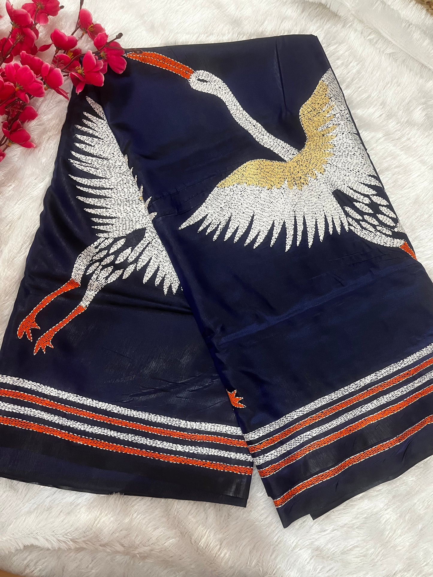 Close-up of crane motif kantha hand embroidery on royal blue Bangalore silk fabric