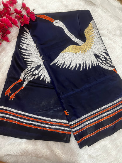 Close-up of crane motif kantha hand embroidery on royal blue Bangalore silk fabric