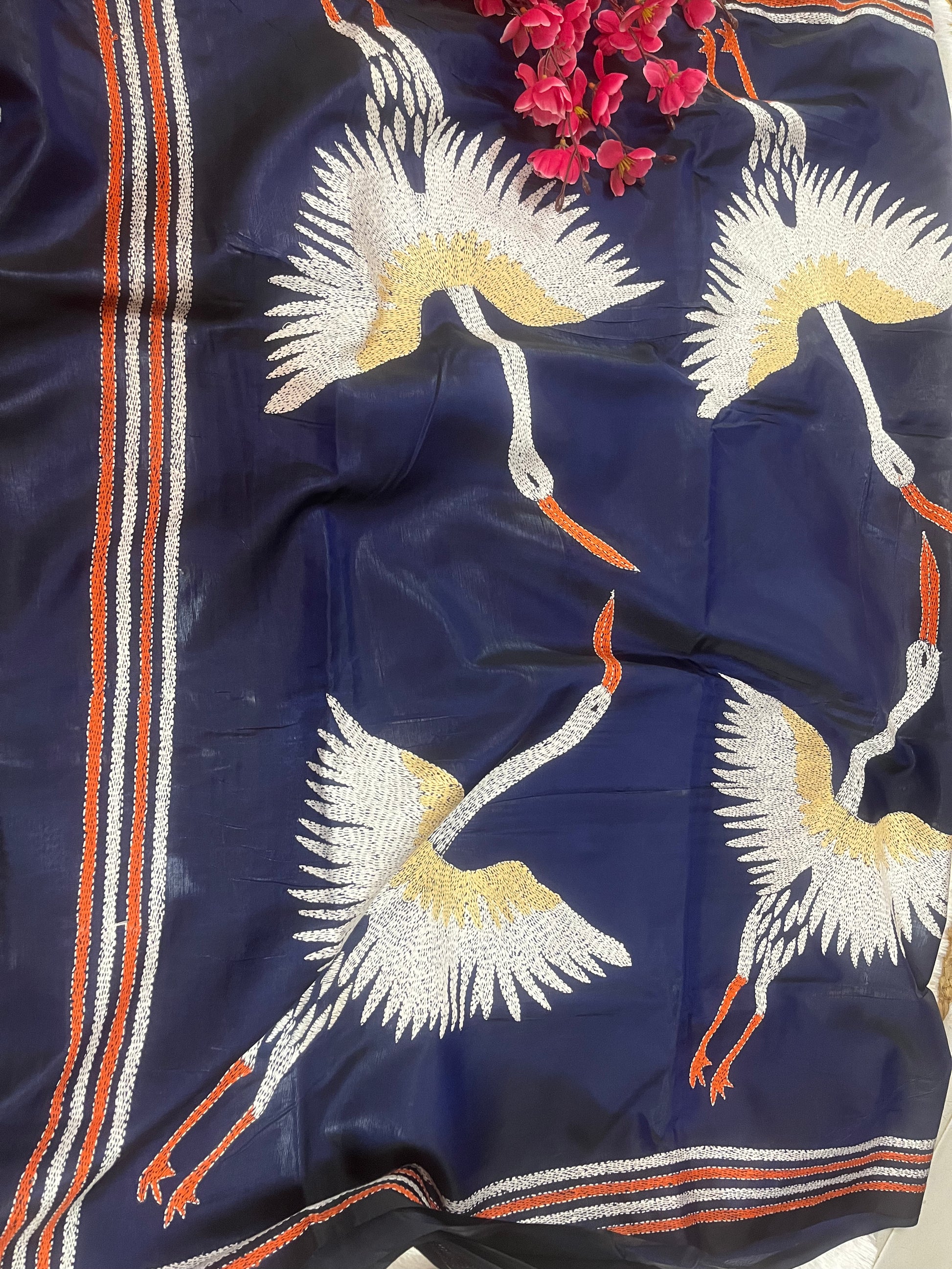 Close-up of crane motif kantha hand embroidery on royal blue Bangalore silk fabric