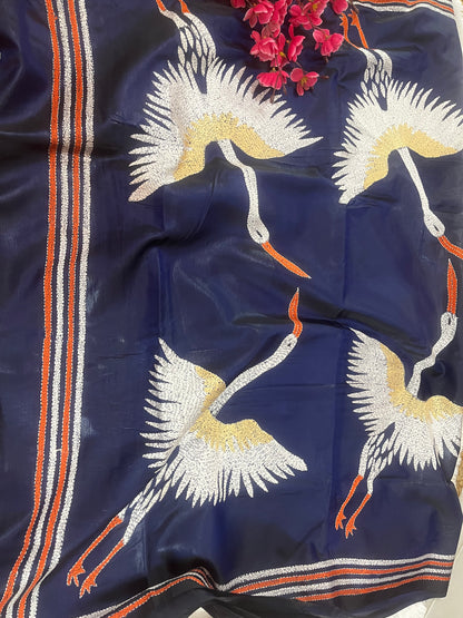 Close-up of crane motif kantha hand embroidery on royal blue Bangalore silk fabric
