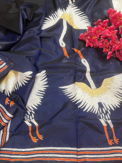 Close-up of crane motif kantha hand embroidery on royal blue Bangalore silk fabric