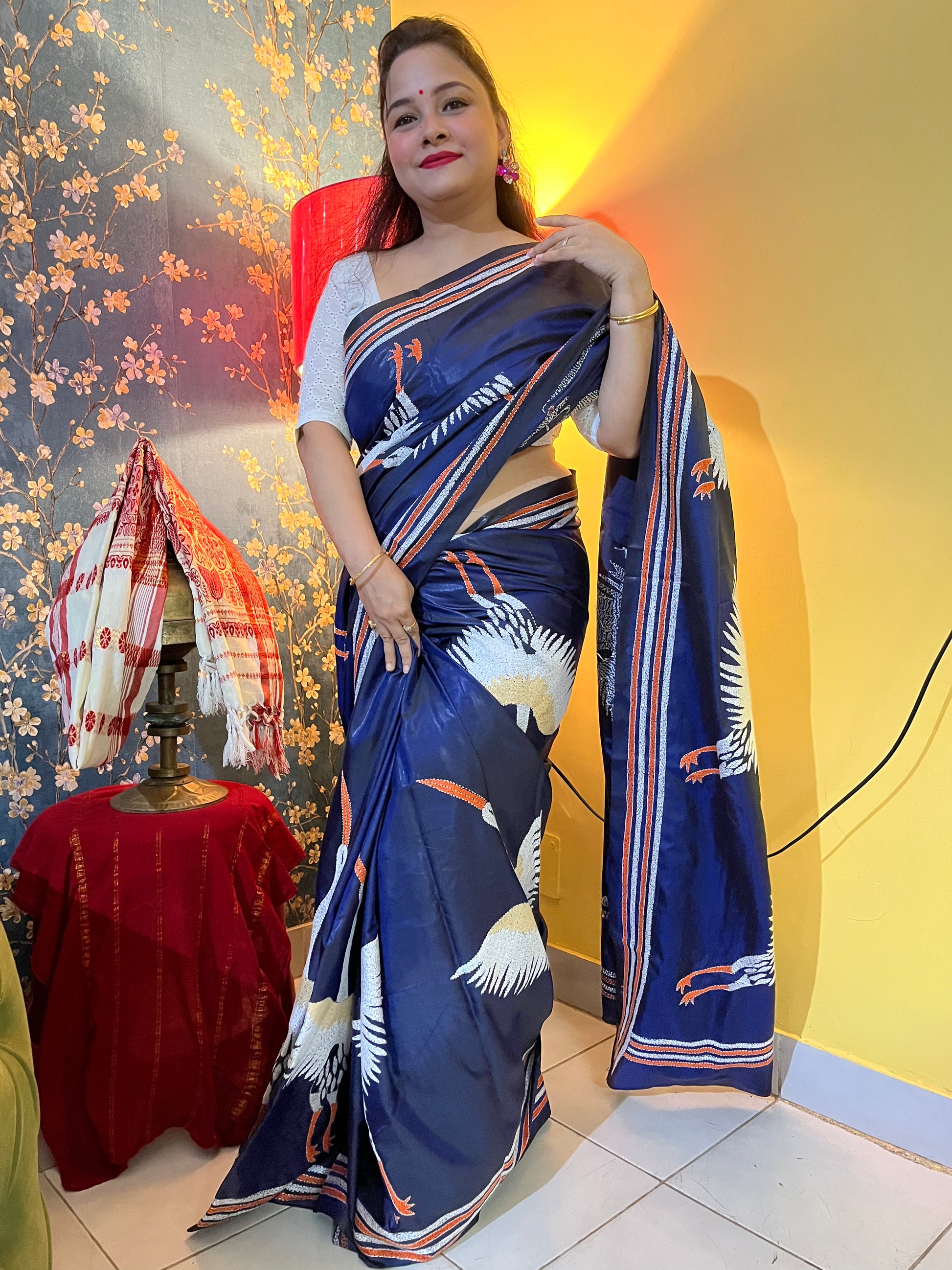 Close-up of crane motif kantha hand embroidery on royal blue Bangalore silk fabric